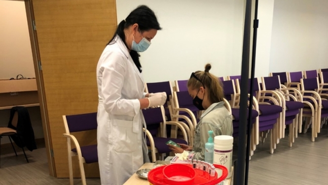 Medicīnas darbinieks veic vakcināciju
