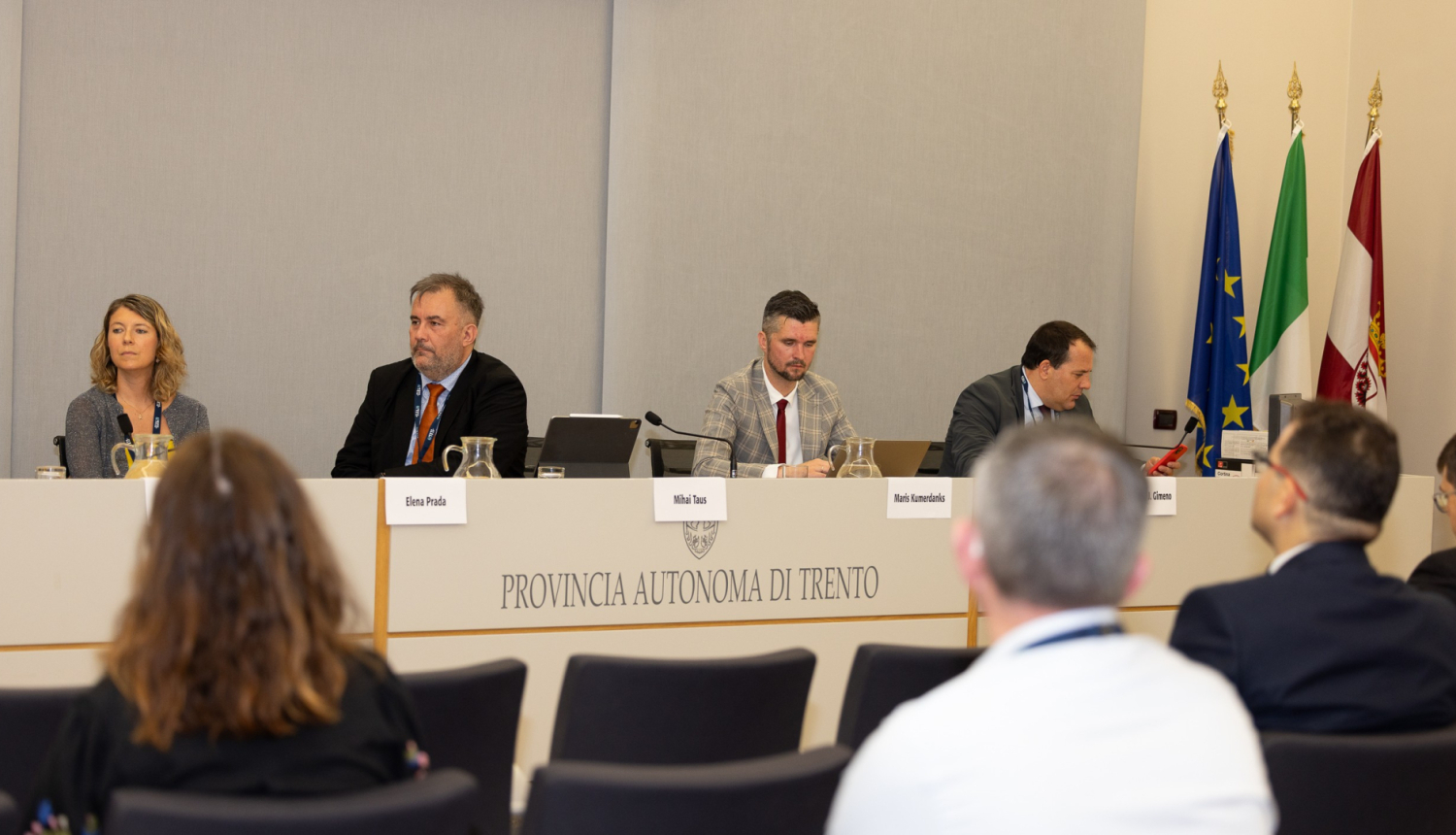 Attēlā attēloti četri delegācijas pārstāvji, kuri atrodas konferenču telpā