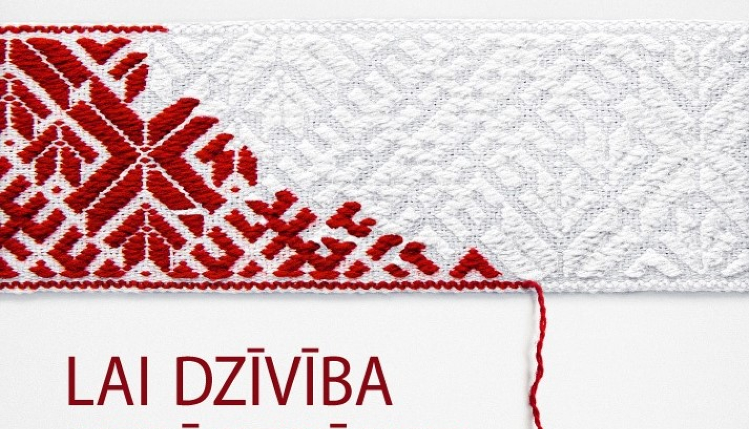 Irstoša Lielvārdes josta un uzraksts "Lai dzīvība nepārtrūkst".